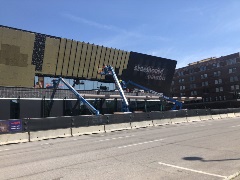 Construction workers clad the outside of Steelhouse Omaha in the iconic black steel cladding. 