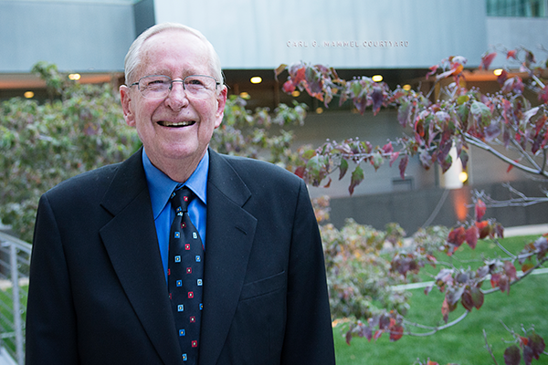 Carl Mammel poses in the courtyard dedicated in his honor