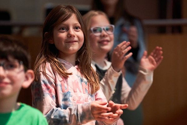 Students clapping at the Holland Center